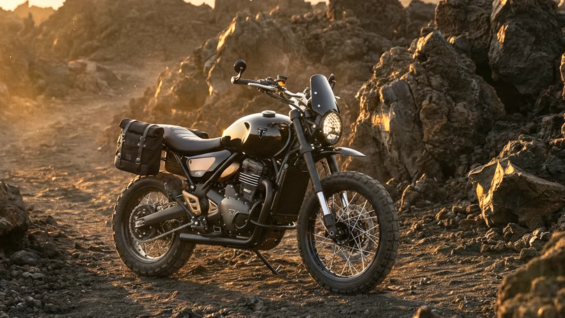 Triumph Scrambler 400 XC Black sur terrain volcanique, équipé d’accessoires Adventure et d’un pare-brise Rally
